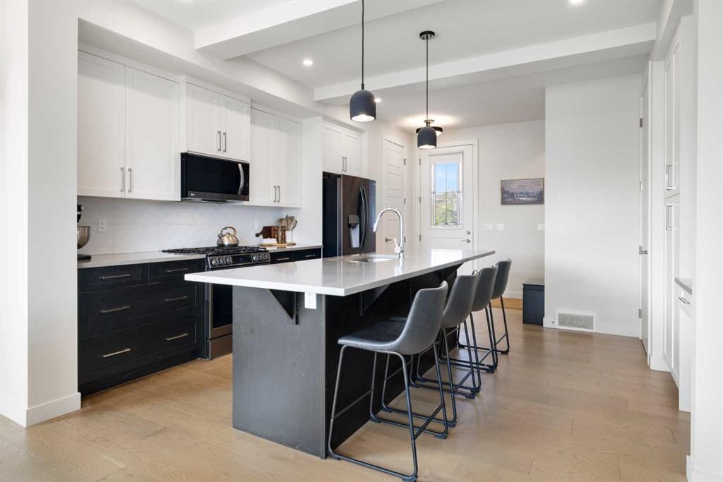 4 Mill Road, Cochrane, AB - Indoor Photo Showing Kitchen With Upgraded Kitchen