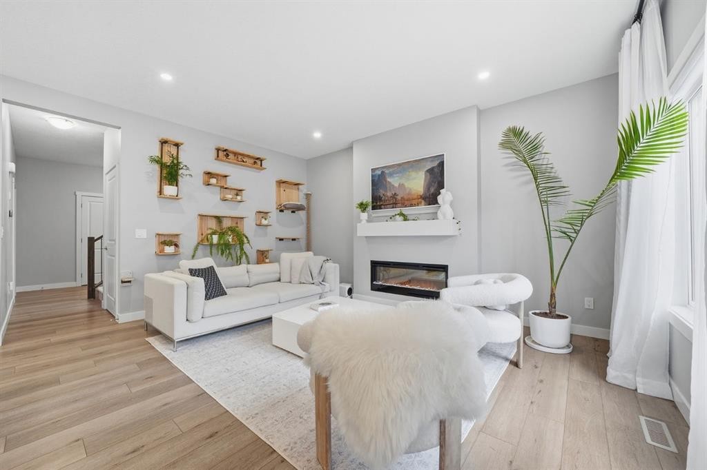 902 Bluerock Way Sw, Calgary, AB - Indoor Photo Showing Living Room With Fireplace