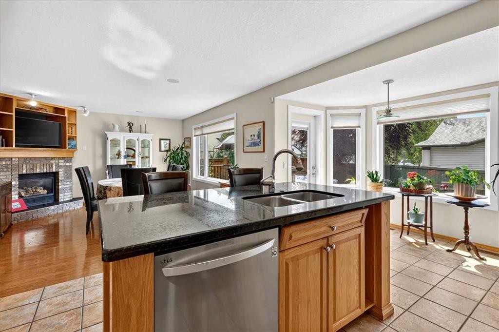23 Cranfield Crescent Se, Calgary, AB - Indoor Photo Showing Kitchen With Fireplace With Double Sink