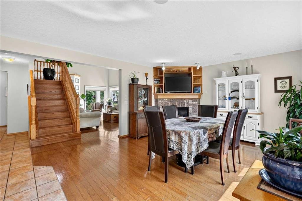 23 Cranfield Crescent Se, Calgary, AB - Indoor Photo Showing Dining Room With Fireplace