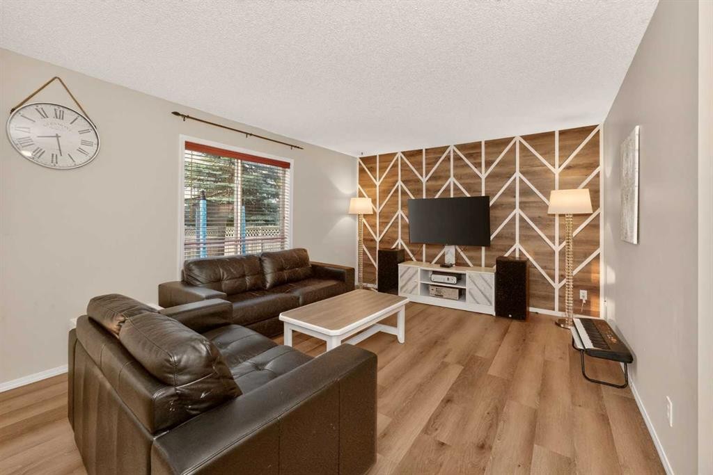 137 Douglas Glen Manor Se, Calgary, AB - Indoor Photo Showing Living Room With Fireplace