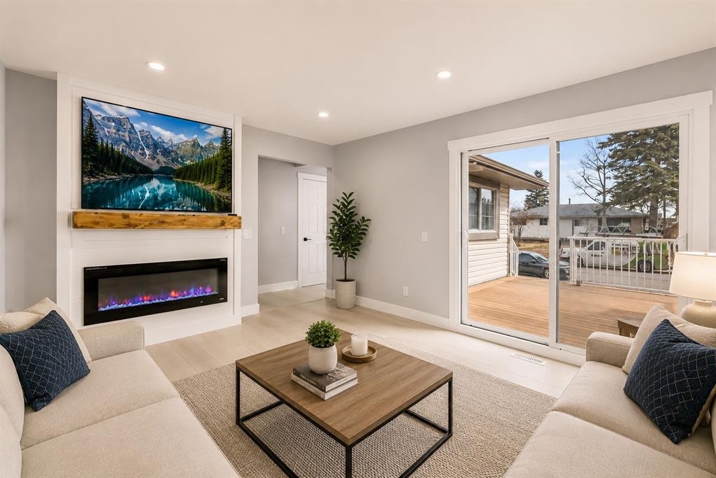 755 Penbrooke Road Se, Calgary, AB - Indoor Photo Showing Living Room With Fireplace