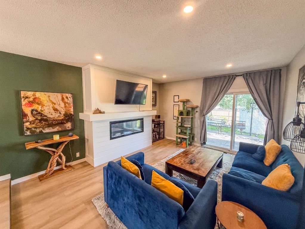 119 Fallswater Crescent Ne, Calgary, AB - Indoor Photo Showing Living Room With Fireplace