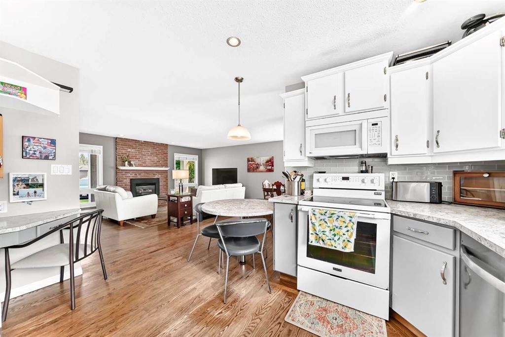 256 Midvalley Place Se, Calgary, AB - Indoor Photo Showing Kitchen With Fireplace