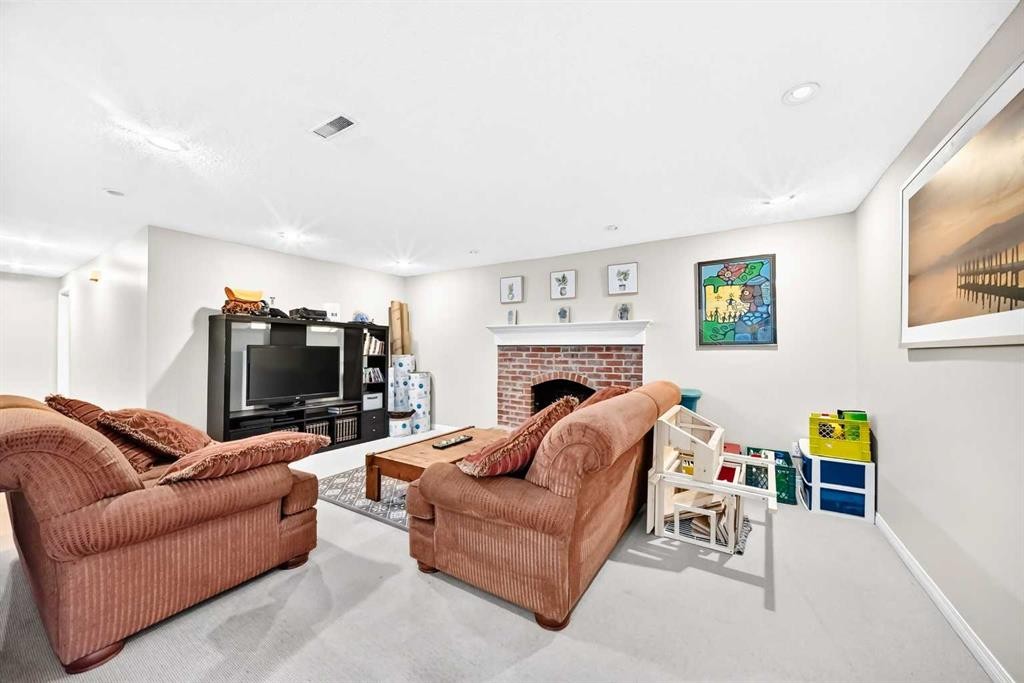 256 Midvalley Place Se, Calgary, AB - Indoor Photo Showing Living Room With Fireplace