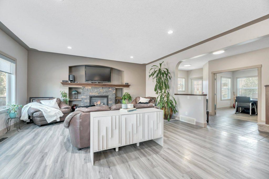101 Hawkmere Place, Chestermere, AB - Indoor Photo Showing Living Room With Fireplace