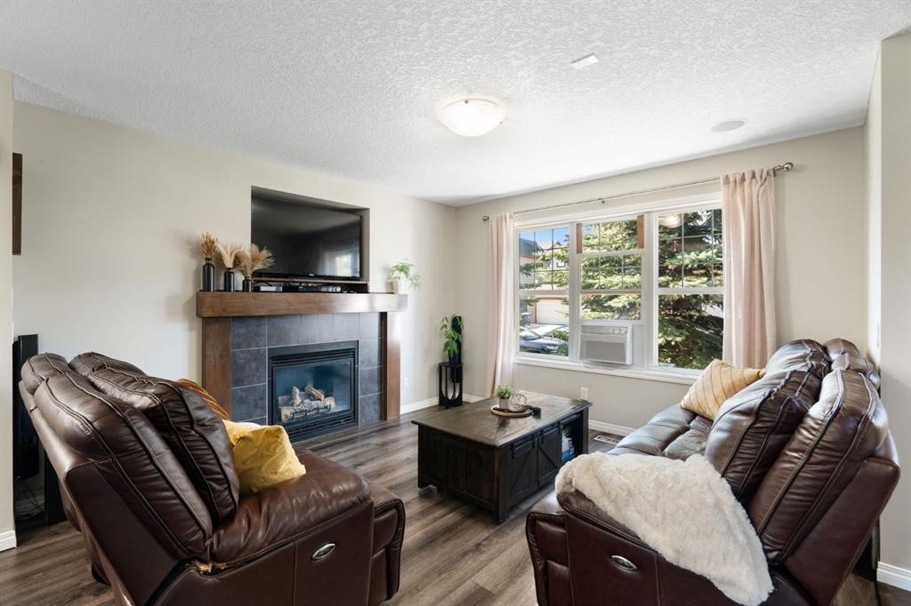 70 Walden Manor Se, Calgary, AB - Indoor Photo Showing Living Room With Fireplace