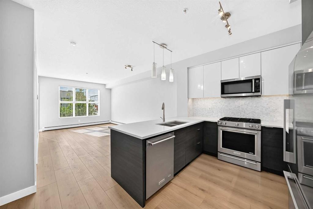 1210-95 Burma Star Road Sw, Calgary, AB - Indoor Photo Showing Kitchen With Stainless Steel Kitchen With Double Sink With Upgraded Kitchen