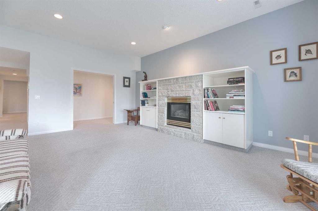8 Prominence Path Sw, Calgary, AB - Indoor Photo Showing Other Room With Fireplace