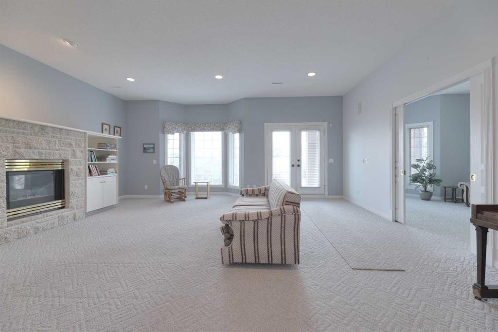8 Prominence Path Sw, Calgary, AB - Indoor Photo Showing Other Room With Fireplace