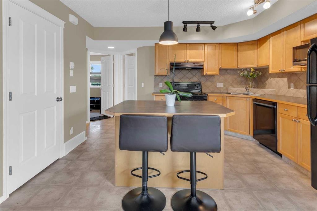 411-140 Sagewood Boulevard Sw, Airdrie, AB - Indoor Photo Showing Kitchen With Double Sink