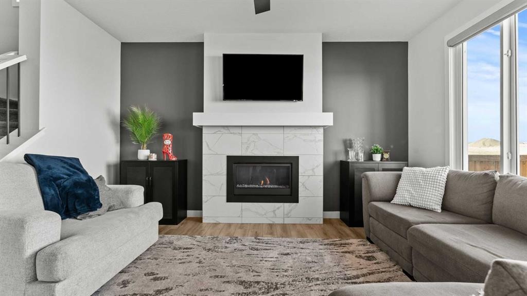 152 Threepoint Cove, Okotoks, AB - Indoor Photo Showing Living Room With Fireplace