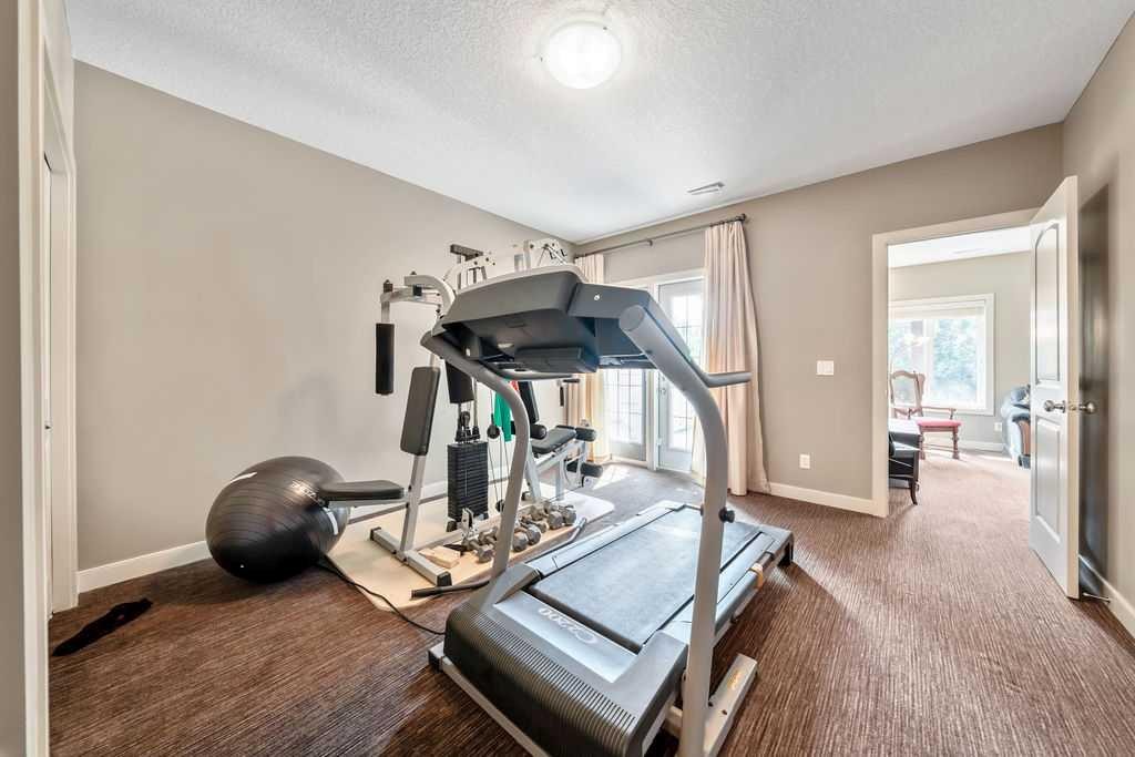 259 Willow Ridge Manor, Diamond Valley, AB - Indoor Photo Showing Gym Room