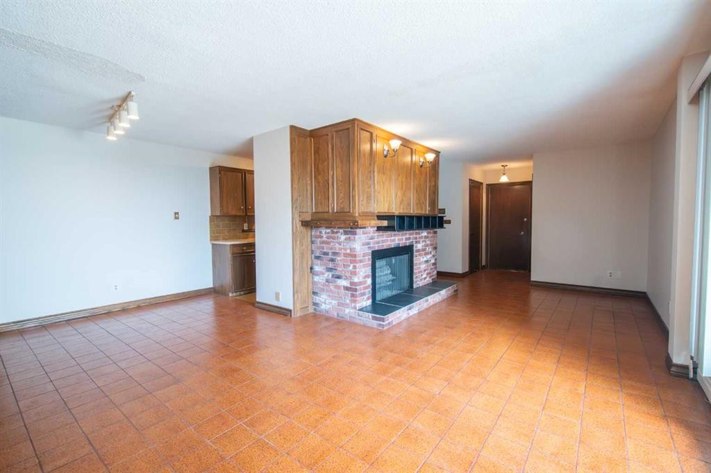 201-512 Cedar Crescent Sw, Calgary, AB - Indoor Photo Showing Other Room With Fireplace