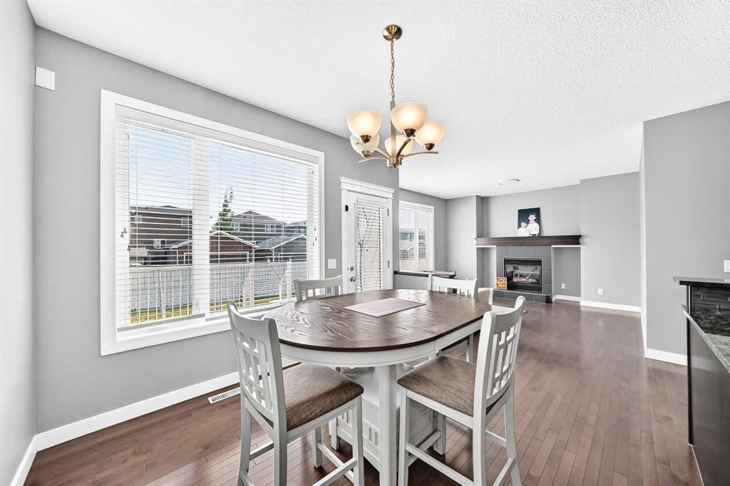 29 Redstone Manor, Calgary, AB - Indoor Photo Showing Dining Room With Fireplace