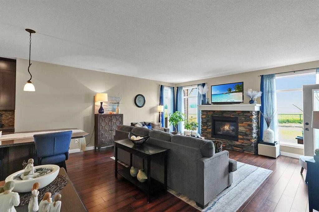 460 Seclusion Valley Drive, Diamond Valley, AB - Indoor Photo Showing Living Room With Fireplace