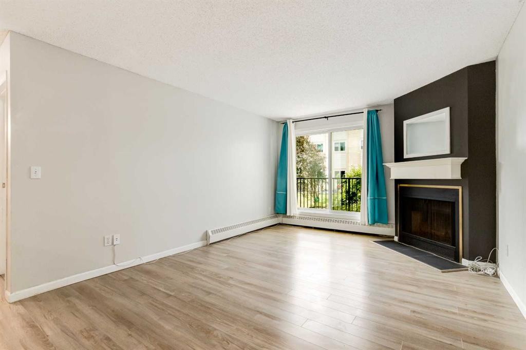 4203-385 Patterson Hill Sw, Calgary, AB - Indoor Photo Showing Living Room With Fireplace