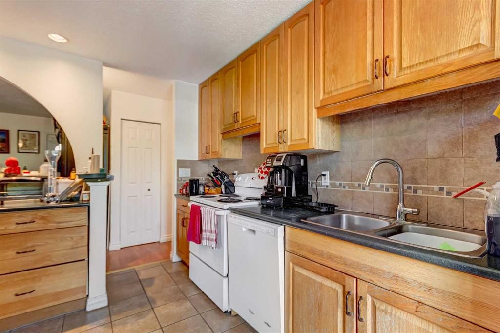 202 Olympia Drive Se, Calgary, AB - Indoor Photo Showing Kitchen With Double Sink