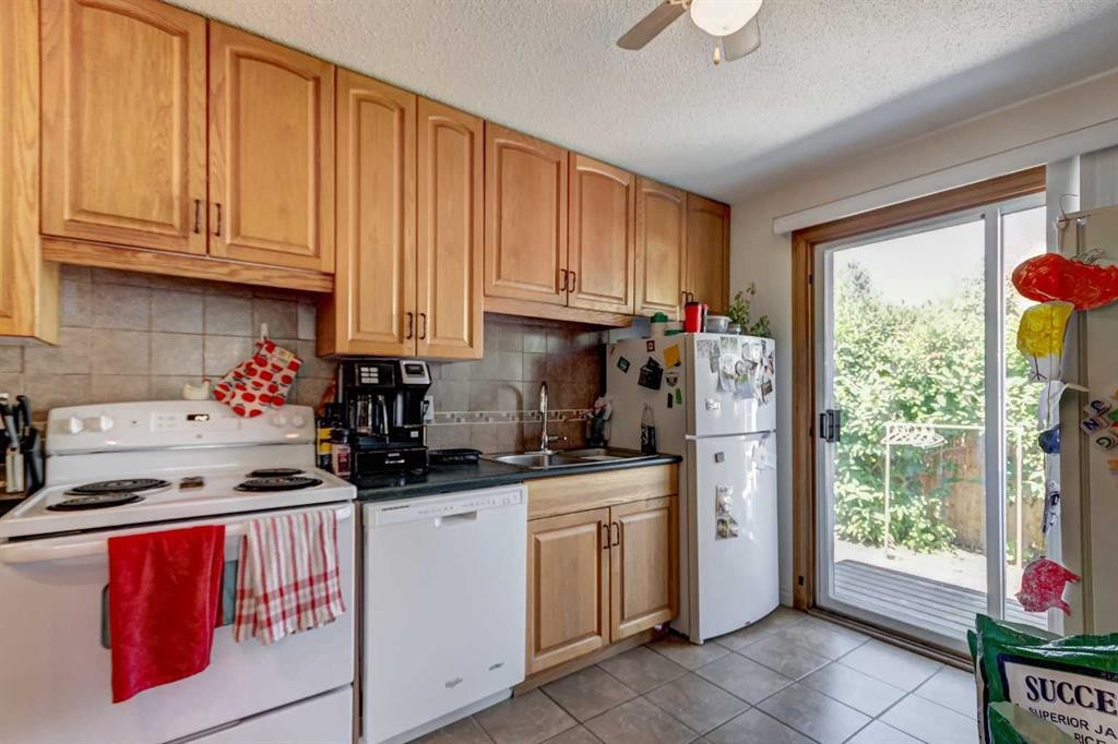 202 Olympia Drive Se, Calgary, AB - Indoor Photo Showing Kitchen With Double Sink
