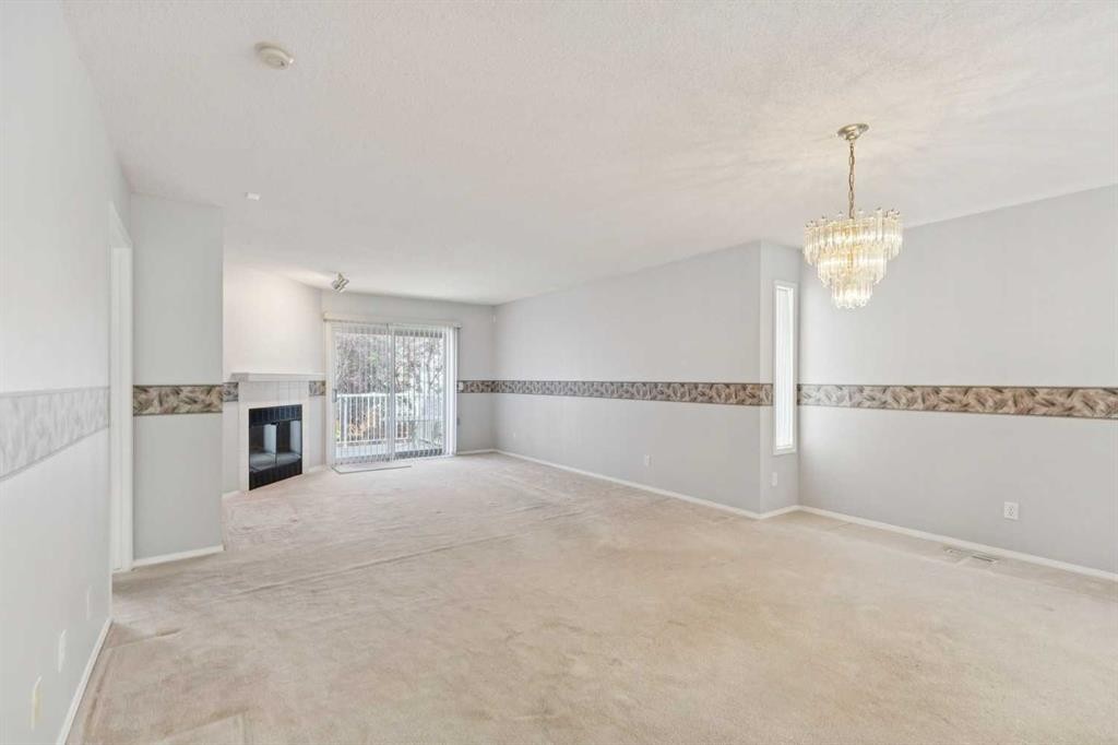 134 Hawkstone Manor Nw, Calgary, AB - Indoor Photo Showing Other Room With Fireplace