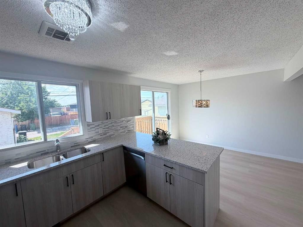215 Penbrooke Way Se, Calgary, AB - Indoor Photo Showing Kitchen With Double Sink