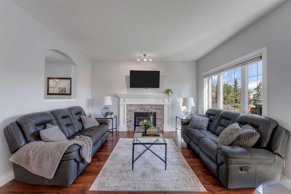 134 Channelside Cove Sw, Airdrie, AB - Indoor Photo Showing Living Room With Fireplace