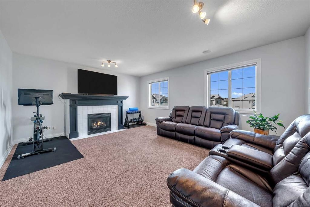 134 Channelside Cove Sw, Airdrie, AB - Indoor Photo Showing Living Room With Fireplace