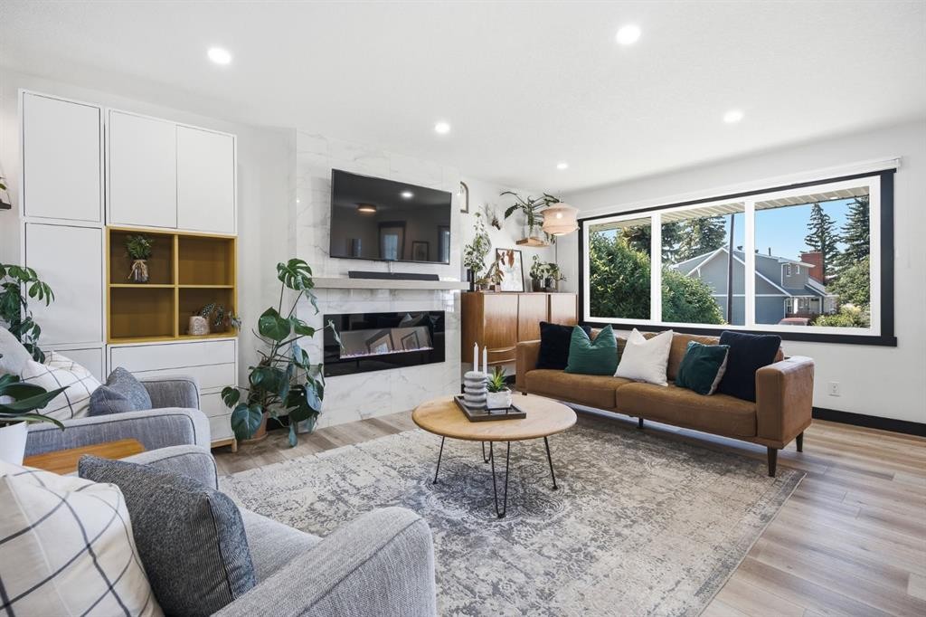 180 Huntford Road Ne, Calgary, AB - Indoor Photo Showing Living Room With Fireplace