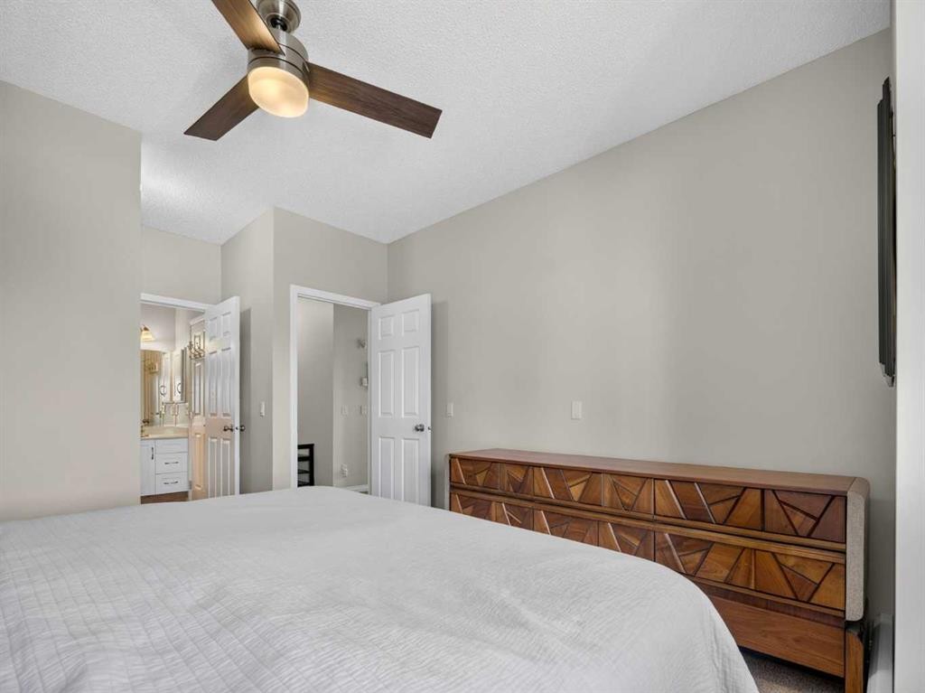 201-72 Quigley Drive, Cochrane, AB - Indoor Photo Showing Bedroom