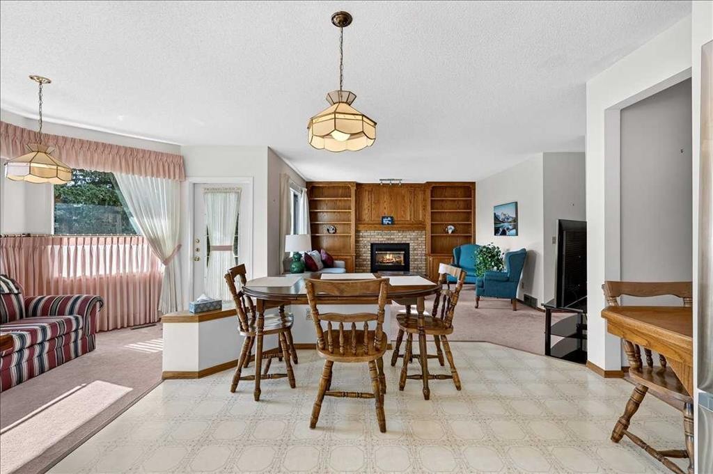 105 Christie Knoll Heights Sw, Calgary, AB - Indoor Photo Showing Dining Room With Fireplace