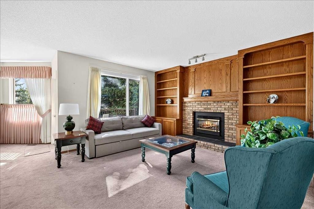105 Christie Knoll Heights Sw, Calgary, AB - Indoor Photo Showing Living Room With Fireplace