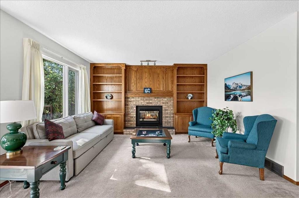 105 Christie Knoll Heights Sw, Calgary, AB - Indoor Photo Showing Living Room With Fireplace