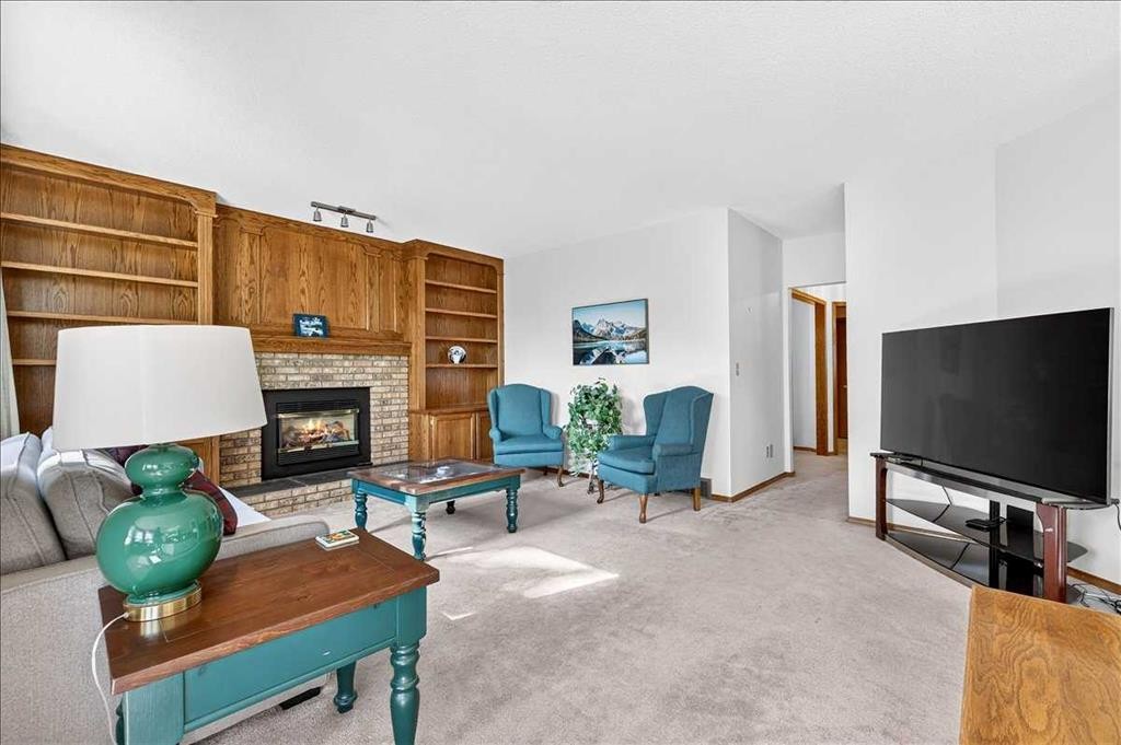 105 Christie Knoll Heights Sw, Calgary, AB - Indoor Photo Showing Living Room With Fireplace