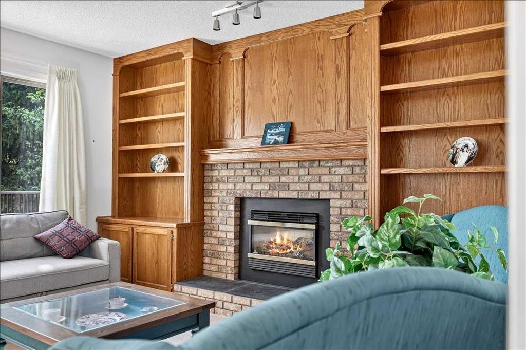 105 Christie Knoll Heights Sw, Calgary, AB - Indoor Photo Showing Living Room With Fireplace