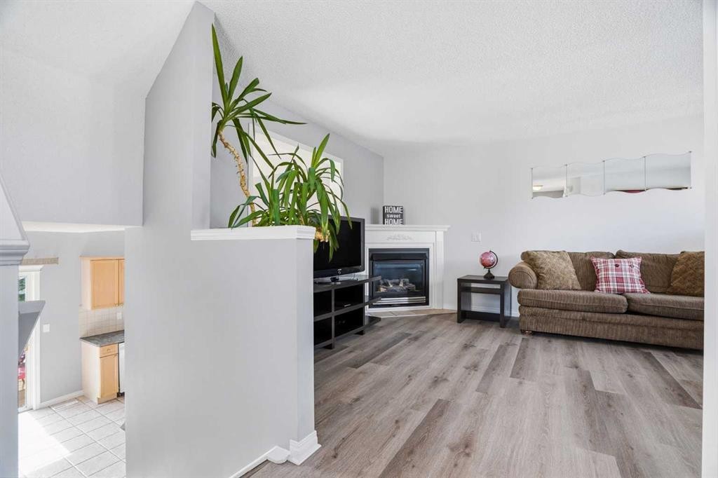 62 Country Hills Cove Nw, Calgary, AB - Indoor Photo Showing Living Room With Fireplace