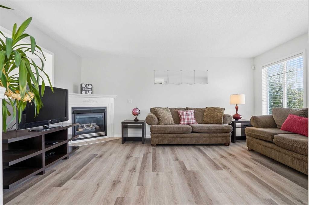 62 Country Hills Cove Nw, Calgary, AB - Indoor Photo Showing Living Room With Fireplace