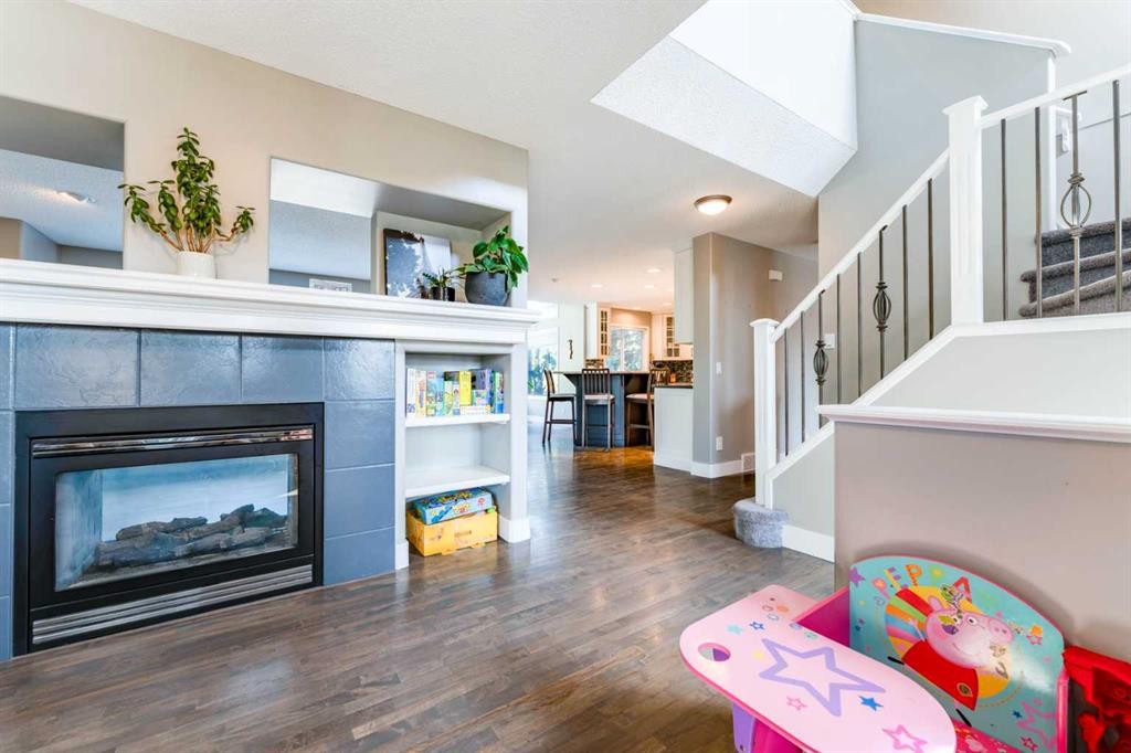 99 Springbluff Boulevard Sw, Calgary, AB - Indoor Photo Showing Living Room With Fireplace