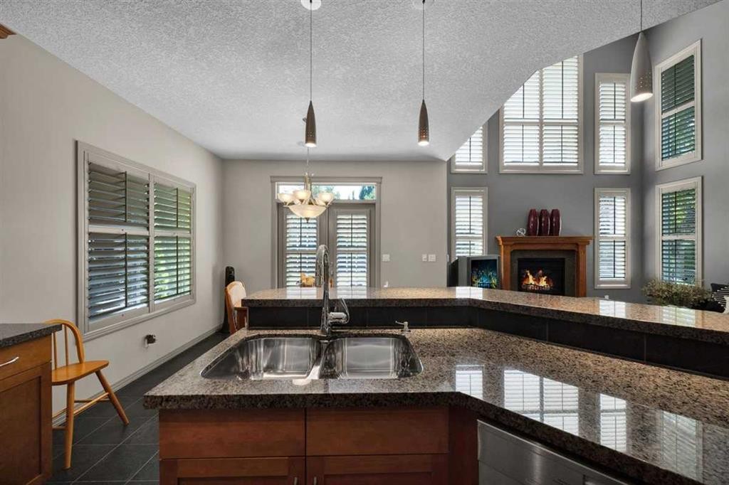 146 Springborough Point Sw, Calgary, AB - Indoor Photo Showing Kitchen With Fireplace With Double Sink