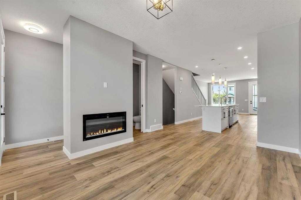 28A Green Meadow Crescent, Strathmore, AB - Indoor Photo Showing Living Room With Fireplace