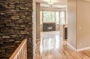 12 Straddock Villas Sw, Calgary, AB  - Indoor Photo Showing Other Room With Fireplace 