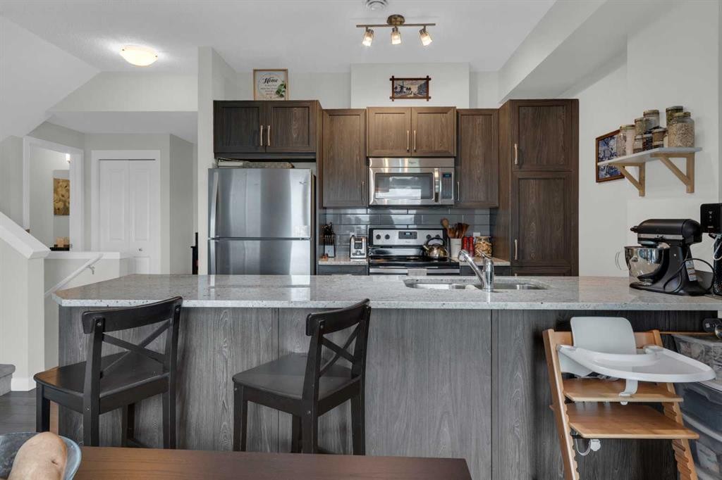 205-250 Fireside View, Cochrane, AB - Indoor Photo Showing Kitchen With Stainless Steel Kitchen With Double Sink
