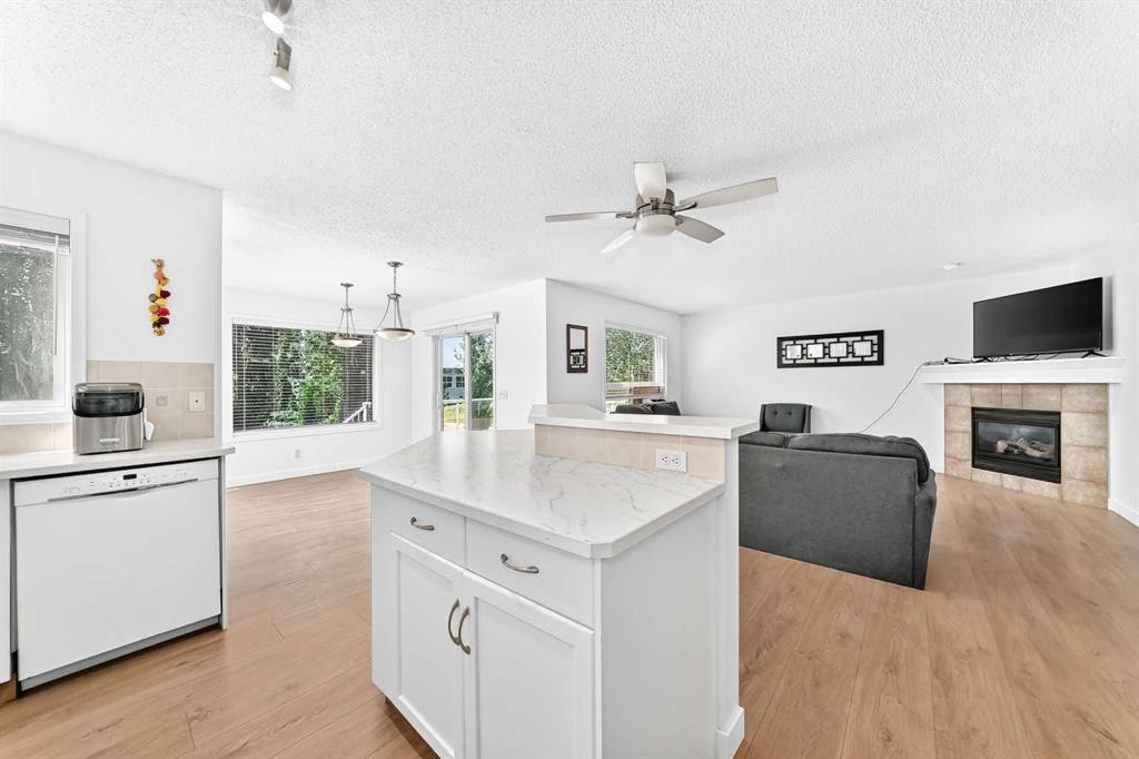 124 West Lakeview Drive, Chestermere, AB - Indoor Photo Showing Kitchen With Fireplace
