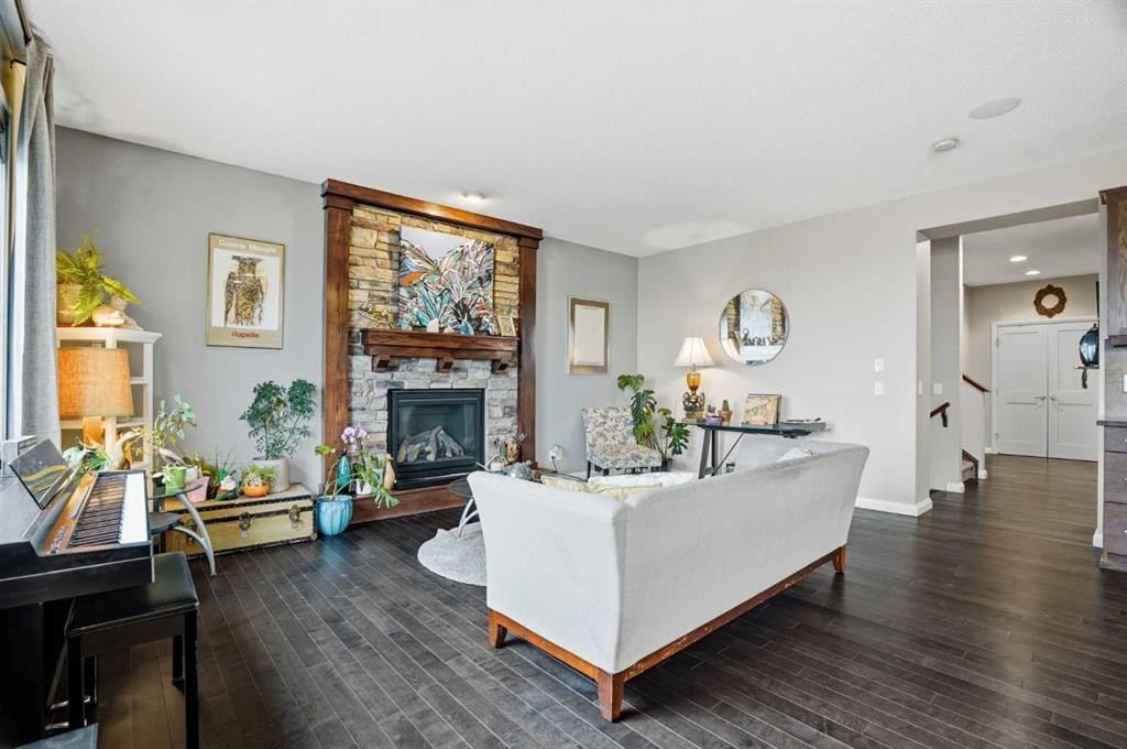 113 Sunset View, Cochrane, AB - Indoor Photo Showing Living Room With Fireplace