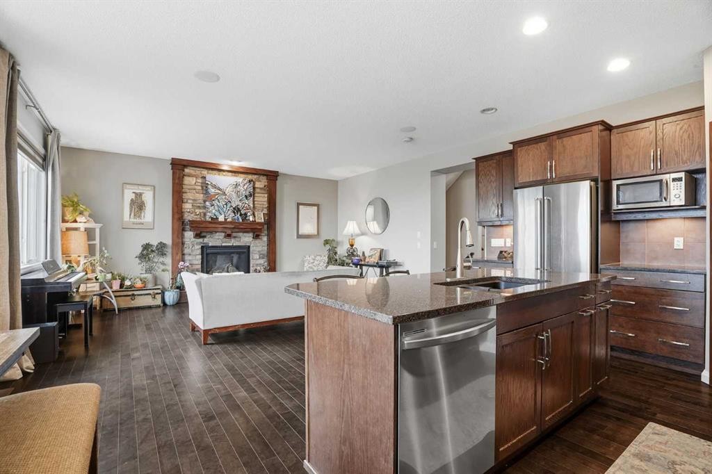 113 Sunset View, Cochrane, AB - Indoor Photo Showing Kitchen With Fireplace With Stainless Steel Kitchen With Upgraded Kitchen