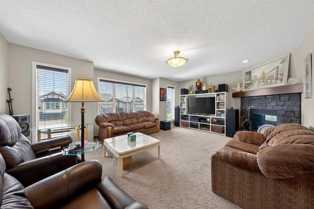 27 Panatella Row Nw, Calgary, AB - Indoor Photo Showing Living Room With Fireplace