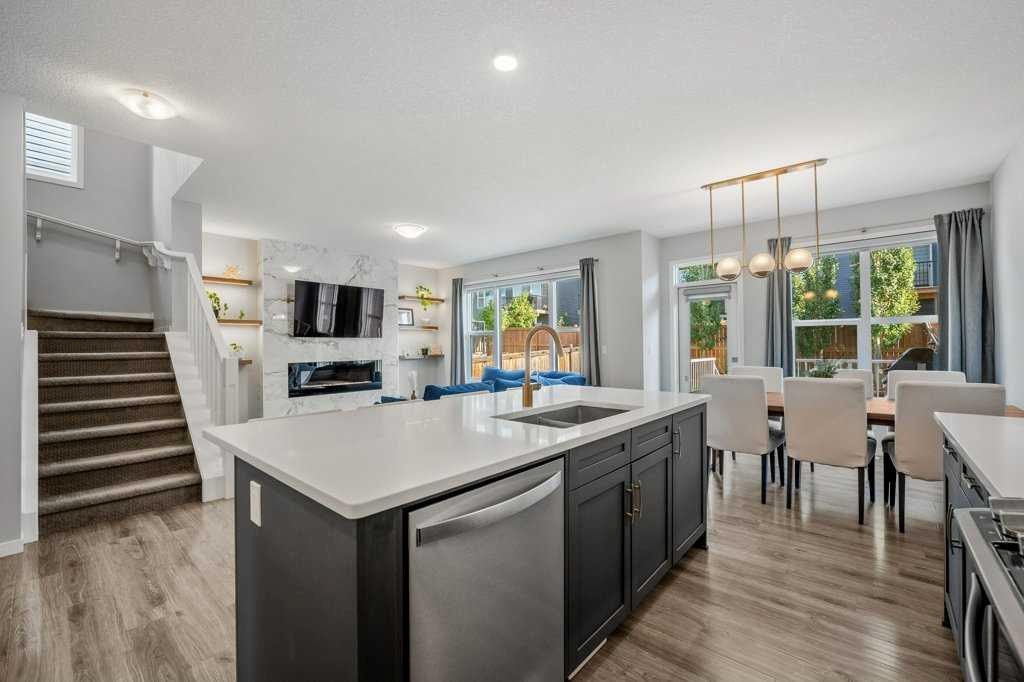 114 Crestbrook Way Sw, Calgary, AB - Indoor Photo Showing Kitchen With Fireplace With Double Sink