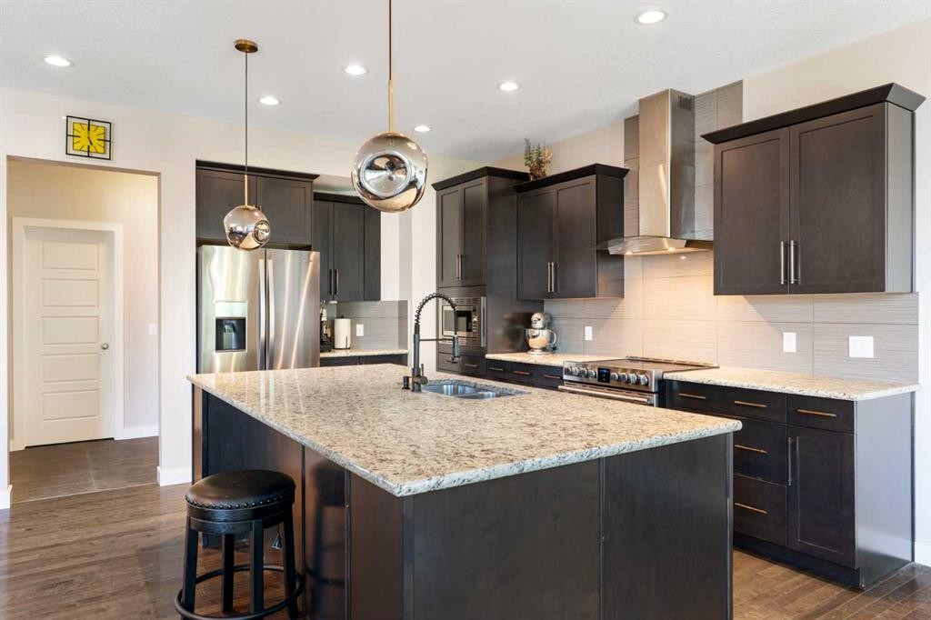 434 River Heights Drive, Cochrane, AB - Indoor Photo Showing Kitchen With Stainless Steel Kitchen With Double Sink With Upgraded Kitchen