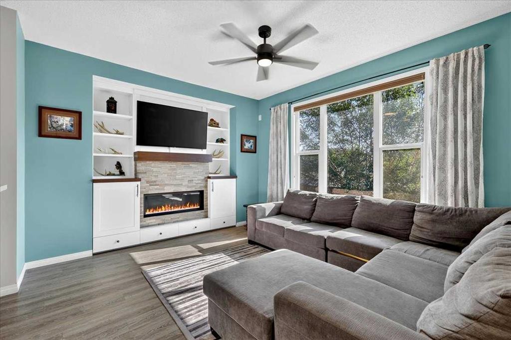 21 Mcintyre Place Nw, Langdon, AB - Indoor Photo Showing Living Room With Fireplace