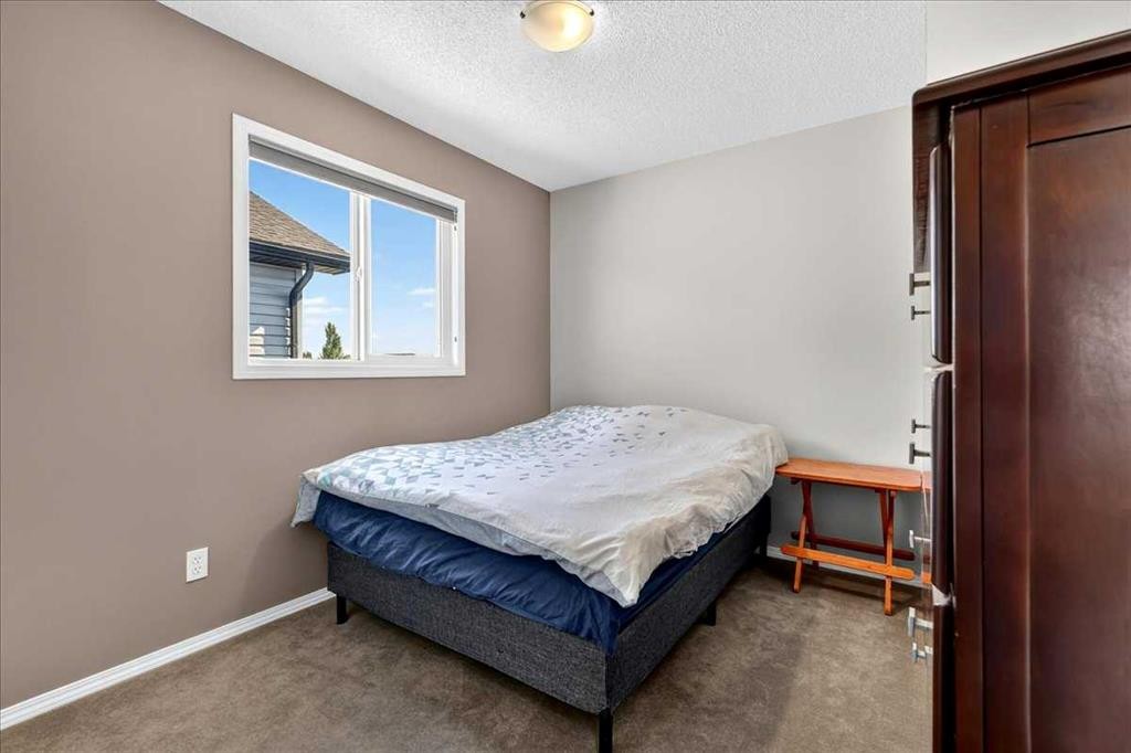 21 Mcintyre Place Nw, Langdon, AB - Indoor Photo Showing Bedroom