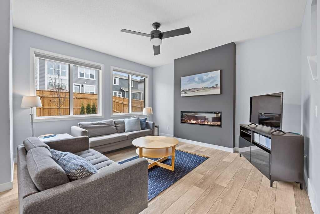 338 Magnolia Way Se, Calgary, AB - Indoor Photo Showing Living Room With Fireplace